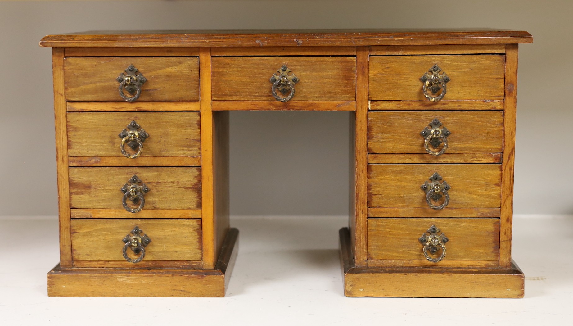 A late 19th century walnut model of a pedestal desk. W- 48cm, H - 27cm, D - 22cm